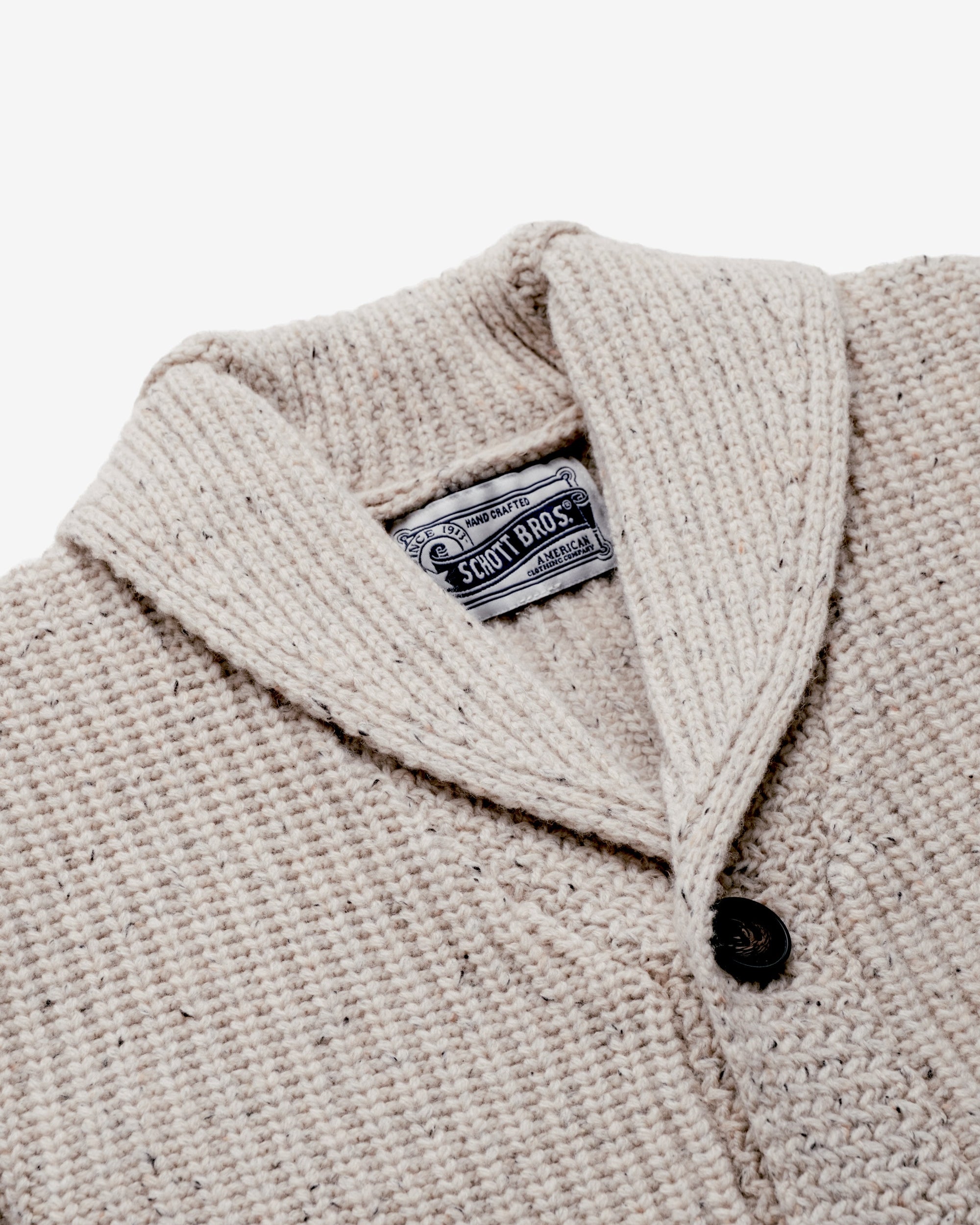 Lower front patch pocket detail on an off white Donegal-inspired wool cardigan - The Simple Man