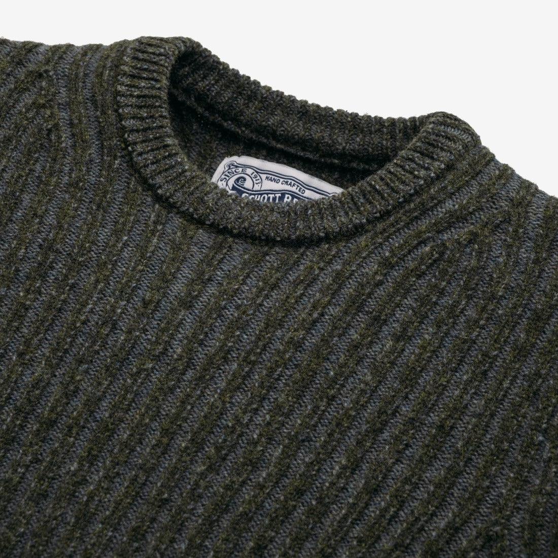 Close detail of moss green shaker knit texture on a wool blend sweater - The Simple Man