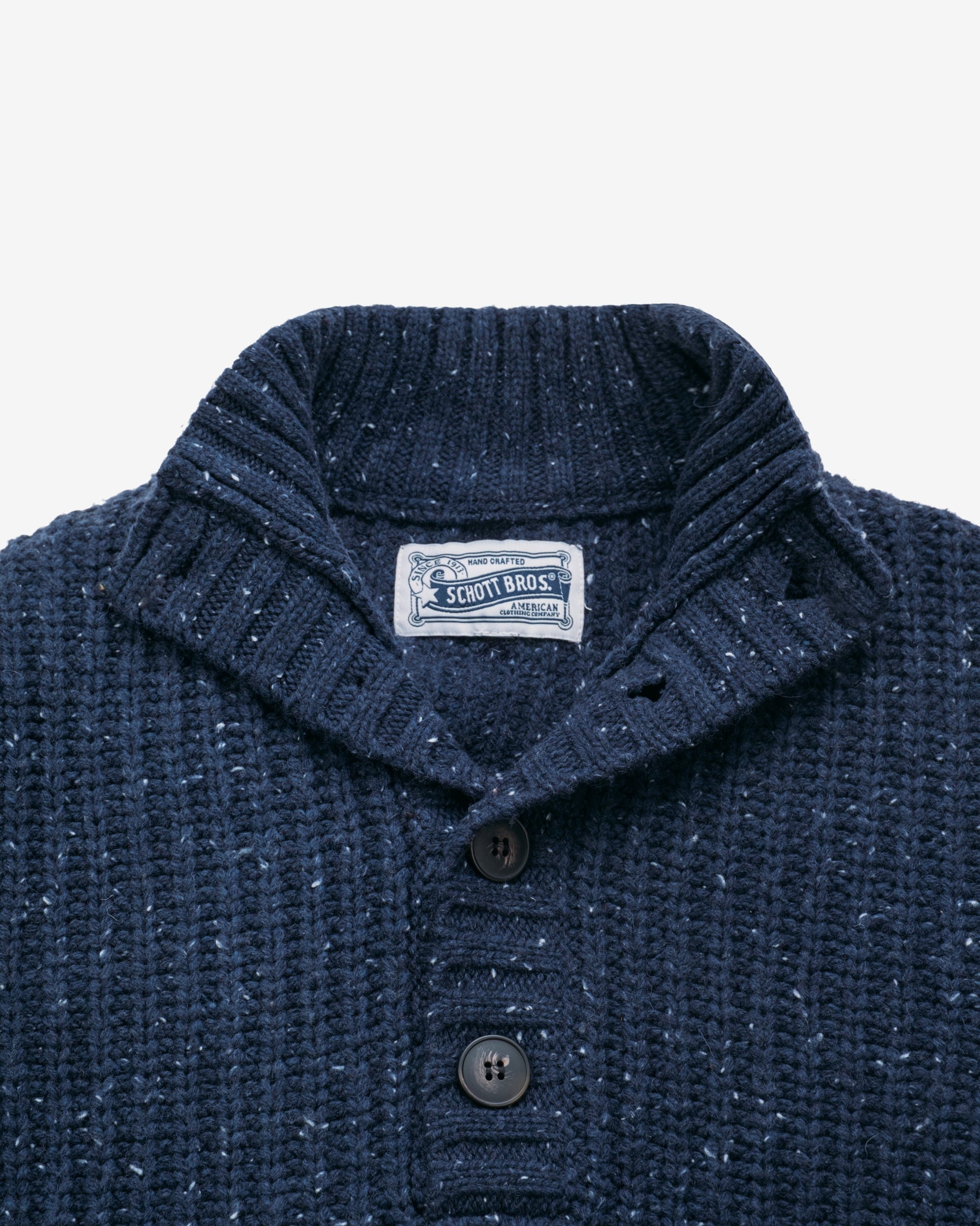 Close-up of the ribbed high neck and button placket on the navy Donegal wool blend pullover sweater - The Simple Man