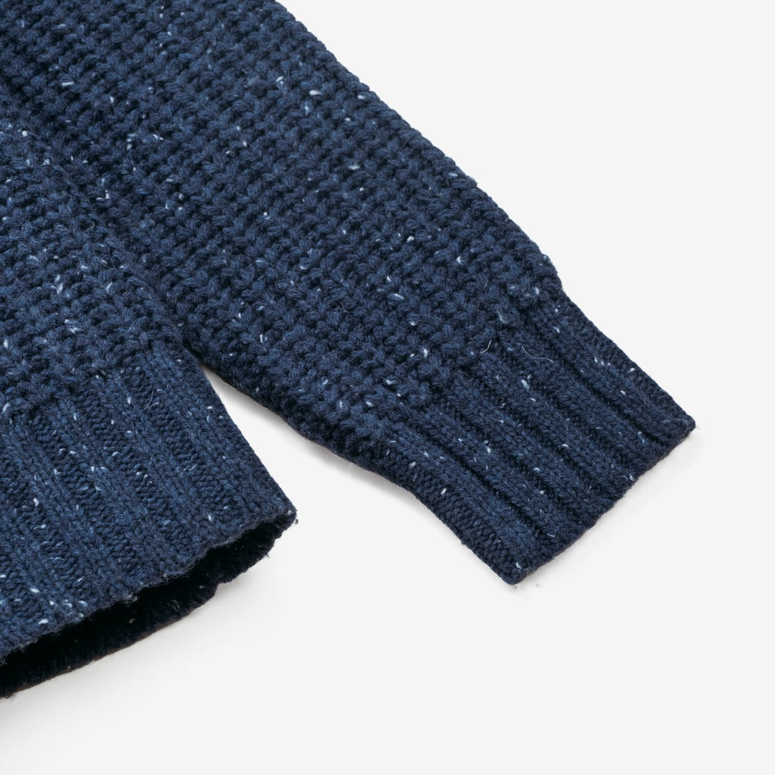 Close-up of the ribbed cuff and flecked wool blend knit on the navy Donegal pullover sweater - The Simple Man