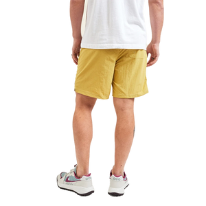 Model Wearing Howler Brothers Salado Shorts in Old Gold color, rear view