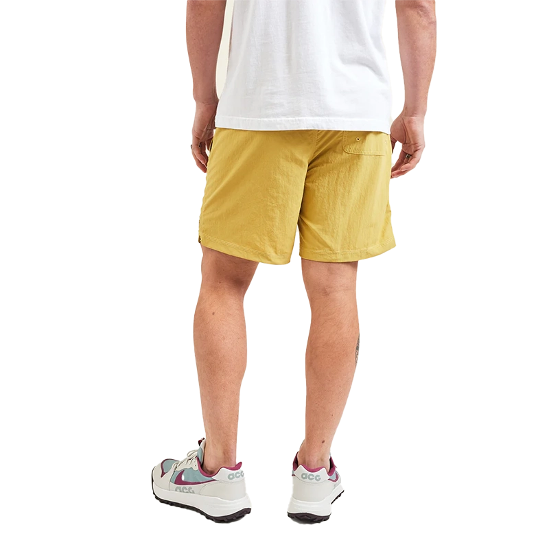 Model Wearing Howler Brothers Salado Shorts in Old Gold color, rear view