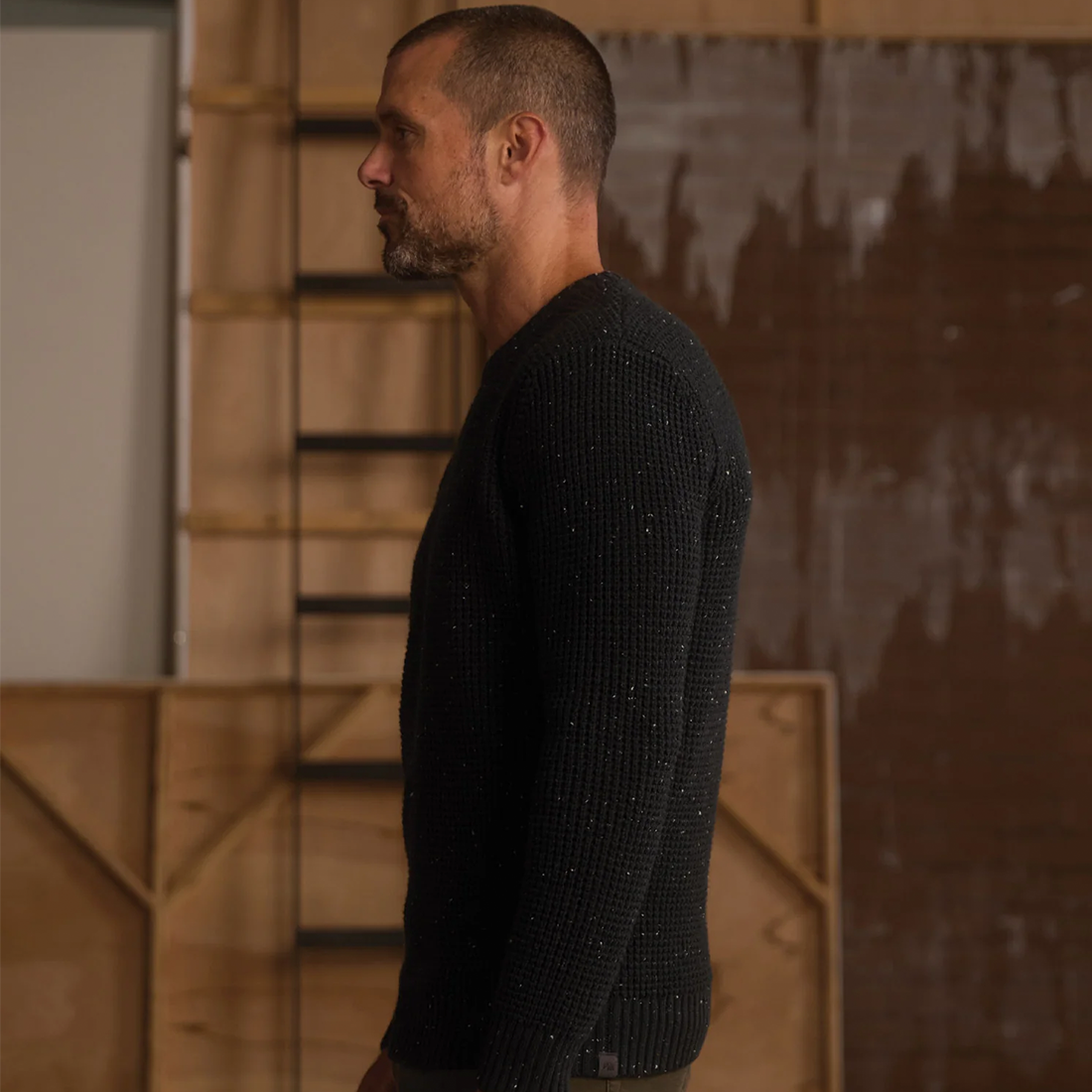 Man wearing Seawool Nep Crew sweater in Charcoal, side profile view