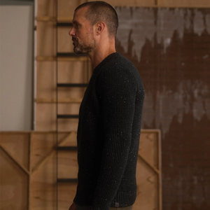 Man wearing Seawool Nep Crew sweater in Charcoal, side profile view