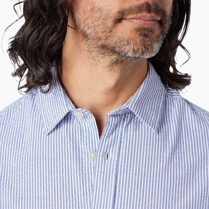 Model Wearing Fair Harbor Seersucker Short sleeve shirt in light blue, front close up fabric detail view