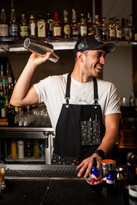 Lifestyle photo showing Bull in China silver weighted cocktail shaker with cheater tin, being used by a bartender