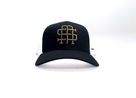 The Simple Man monogram logo tucker hat in Navy/white, front view