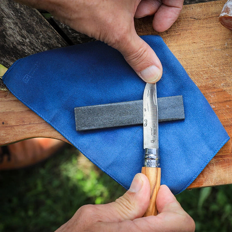 Lifestyle photo showing Opinel Natural sharpening stone and a knife in use
