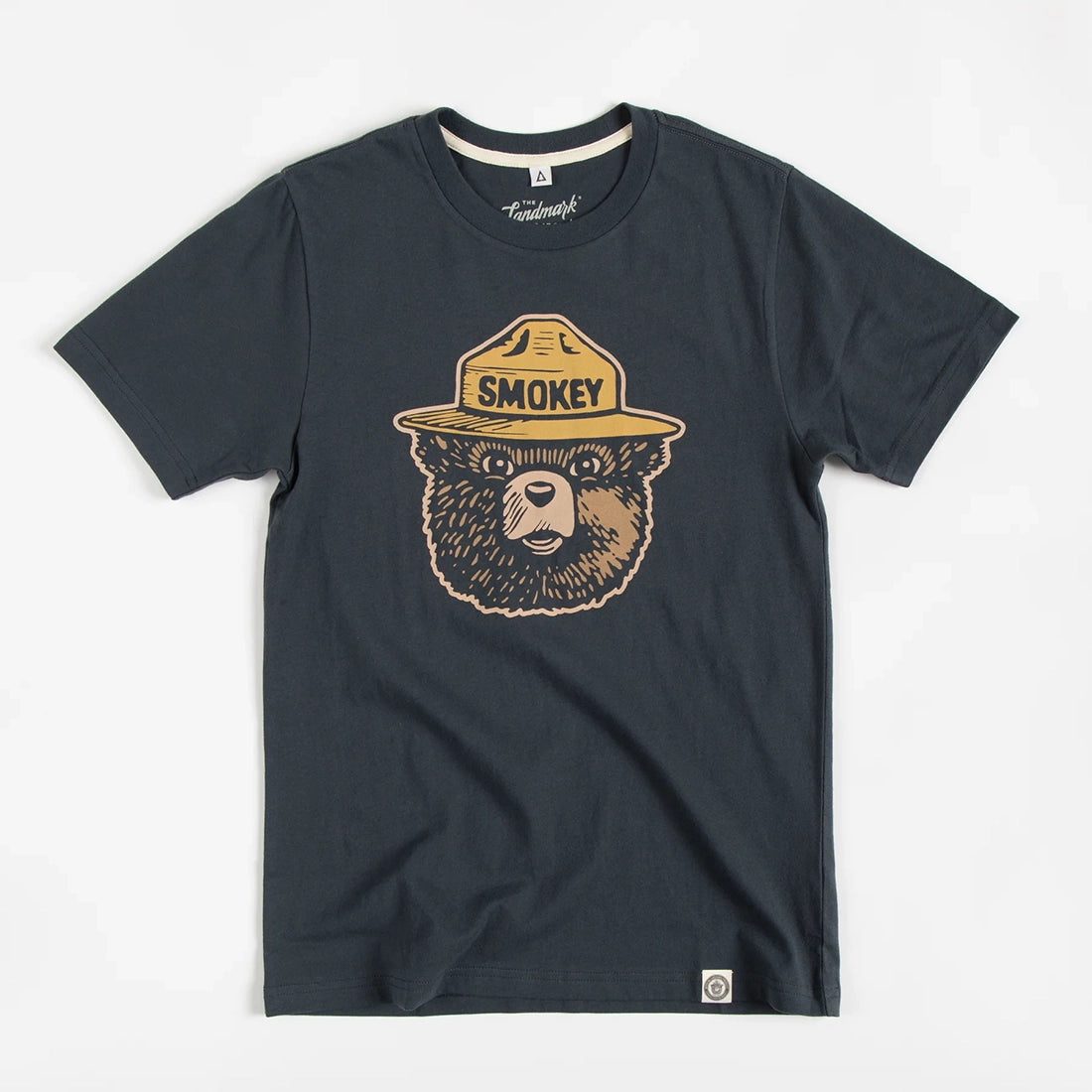 Smokey Bear Logo Tee in Dark Navy by The Landmark Project flat lay