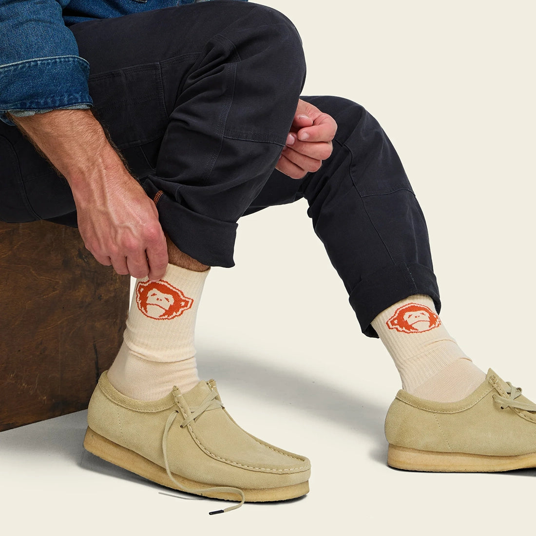El Mono Socks in Sand Orange laid flat, cream crew socks with orange howler monkey graphic and striped toe -- The Simple Man