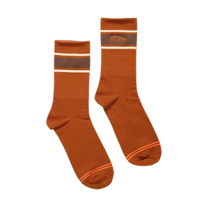 Howler Script Socks in Burnt Orange laid flat, rust orange crew socks with brown and cream stripe and Howler wordmark -- The Simple Man