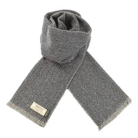 Grey and black herringbone Donegal wool scarf featuring soft Irish wool, subtle flecks, and finished fringe detailing