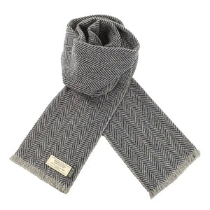 Grey and black herringbone Donegal wool scarf featuring soft Irish wool, subtle flecks, and finished fringe detailing