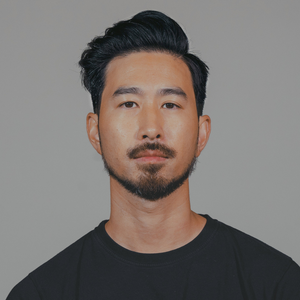 Man with a short side-swept style and trimmed beard, hair styled with Sponge Wax