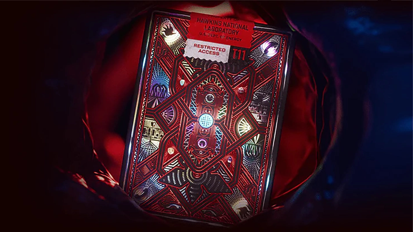 Stranger Things playing card deck back design by Theory11, showcasing Hawkins Lab and red geometric artwork in moody lighting