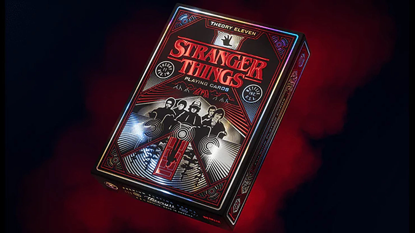 Theory11 Stranger Things playing cards deck with detailed red and black foil packaging on a smoky dark background