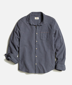 Flat lay of men’s stretch selvage long sleeve shirt in India Ink with pearl buttons