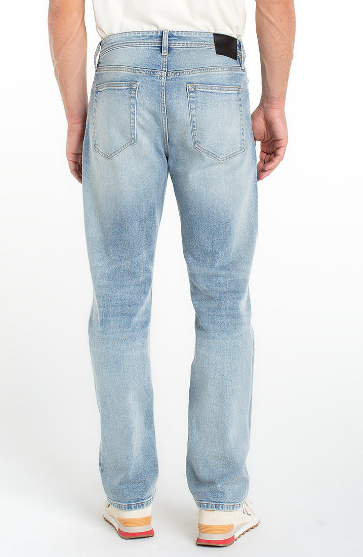 Back view of men’s light wash loose straight jeans with classic pockets