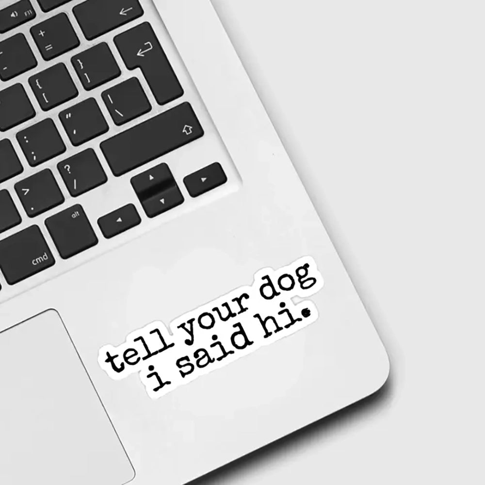 Tell Your Dog I Said Hi” waterproof vinyl sticker on silver laptop – 3 inch black typewriter font decal for dog lovers, perfect for tech gear or gifts