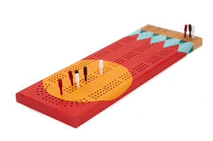 Tettegouche painted cherry wood cribbage board with pegs inserted, red and yellow design inspired by Minnesota.