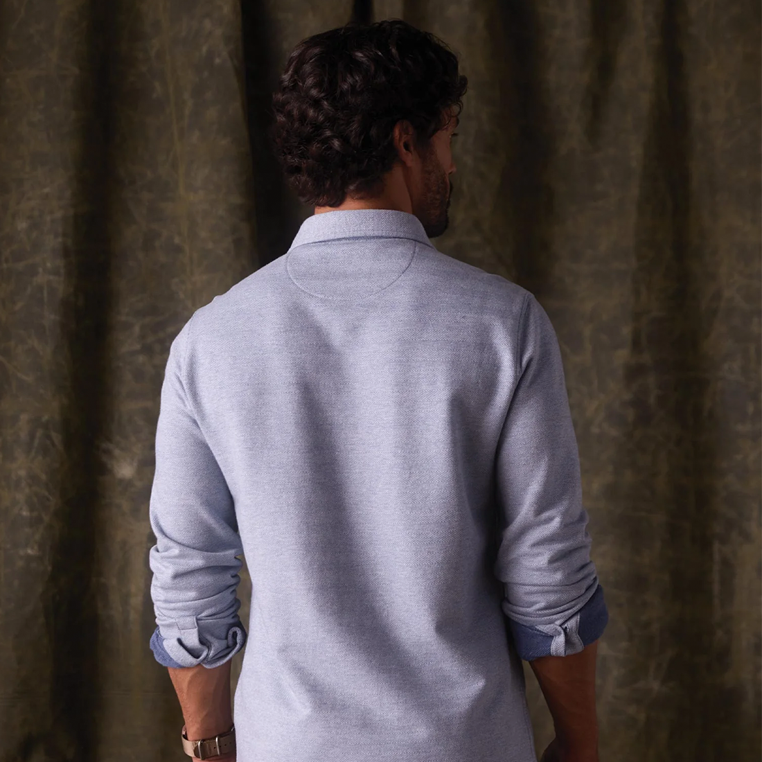 Man wearing Textured Knit Shirt in Vintage Blue, back view showing collar and rolled sleeve cuffs