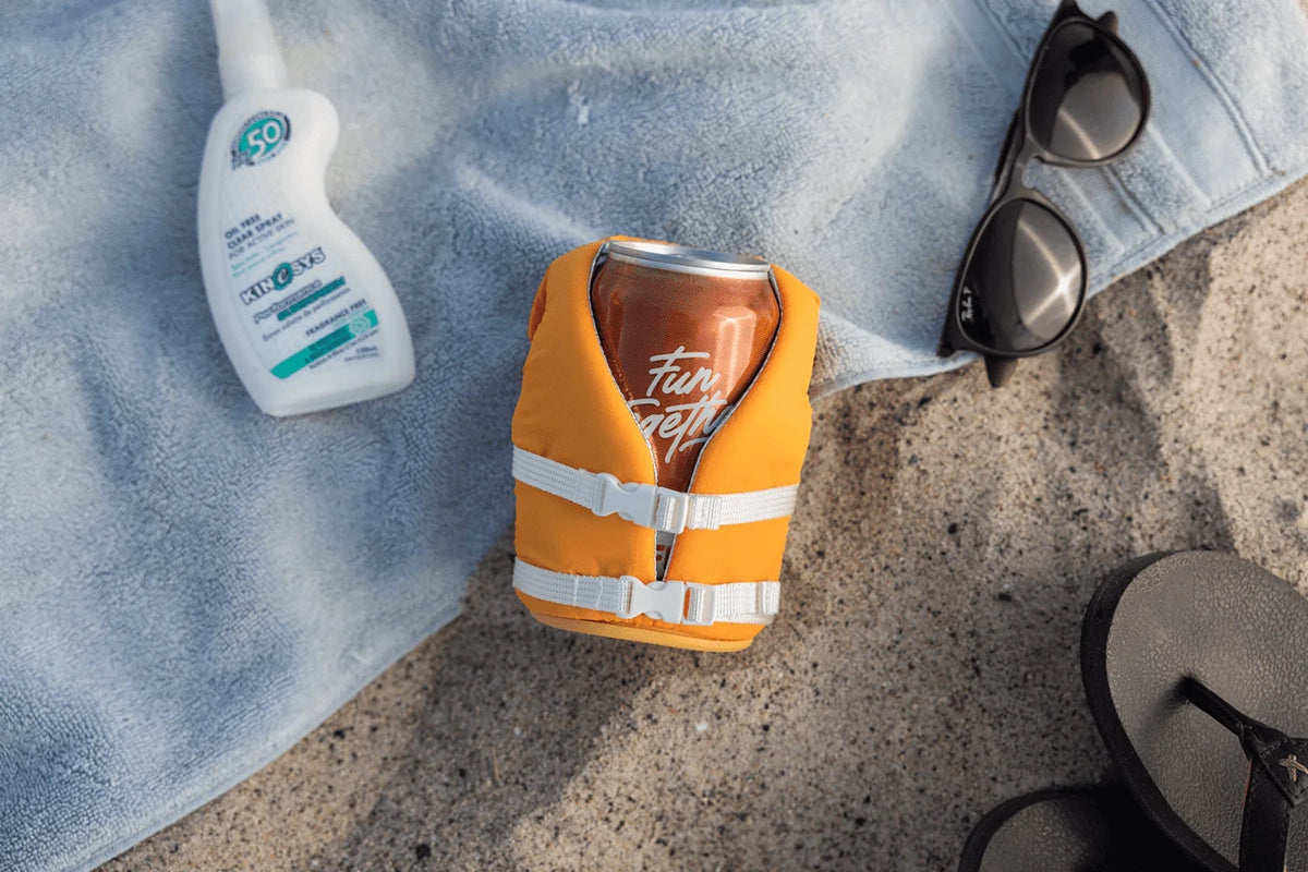 Buoy-style floating can cooler keeping drink cold at the beach
