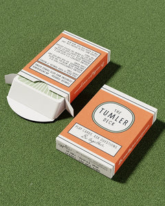 Tumler Deck conversation playing cards in orange box on green surface