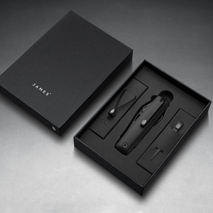 Helton in Black + Black in its box with lanyard and bead, top-down view