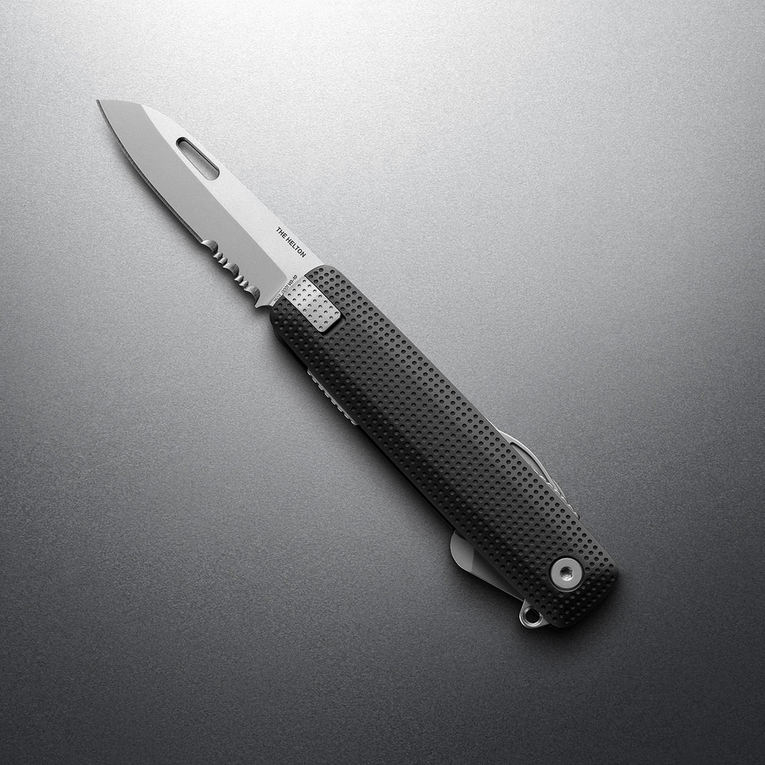 Black + Stainless Helton with partially serrated blade open, angled view