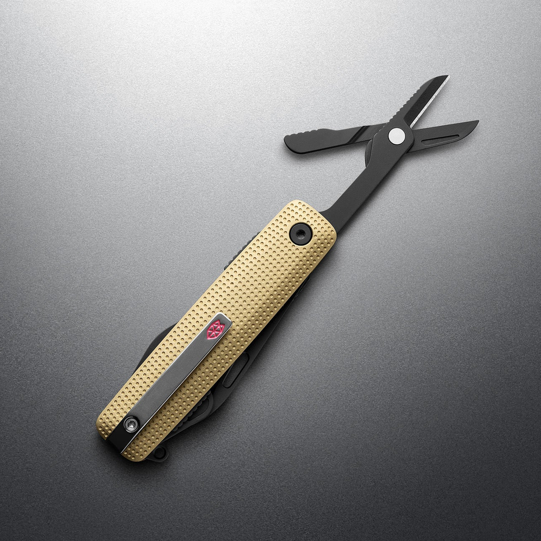 Buttermilk + Black Helton with spring-action scissors open, angled view