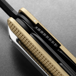 Side detail of the Helton's stacked tools and dot-textured handle in Buttermilk + Black