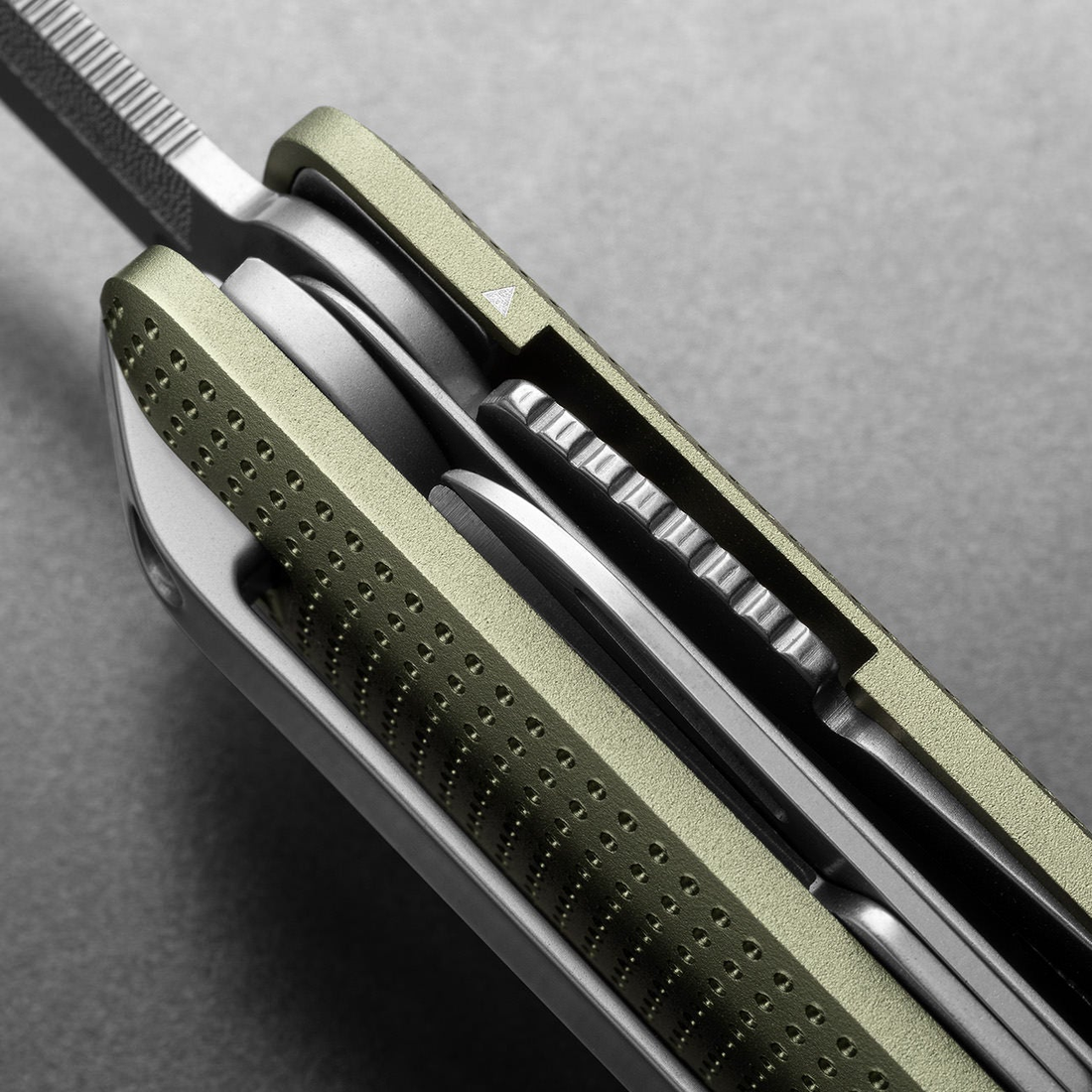 Side detail of the Helton's stacked tools and dot-textured handle in Grove + Stainless