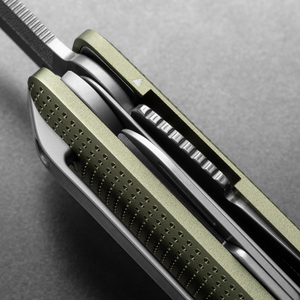 Side detail of the Helton's stacked tools and dot-textured handle in Grove + Stainless