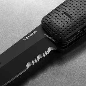 Close-up of the Helton's partially serrated blade and dot grip, Black + Black