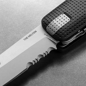 Close-up of the Helton's partially serrated blade and dot grip, Black + Stainless