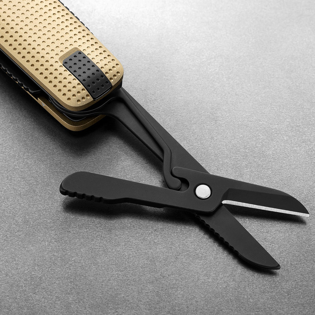 Spring-action scissors open on the Helton in Buttermilk + Black, close-up