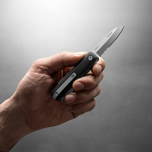 Hand holding the Helton multitool with the blade open