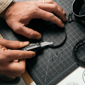 Cutting on a workbench mat with the Helton blade, lifestyle shot