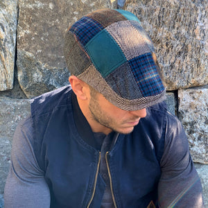 Man wearing the Tradesman patchwork flat cap with a navy jacket