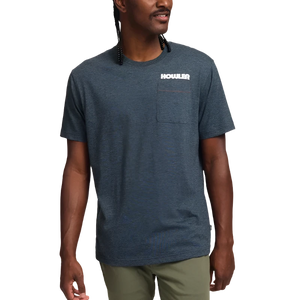 Model wearing Howler Brothers Trucha T-shirt in charcoal, design printed on the back.