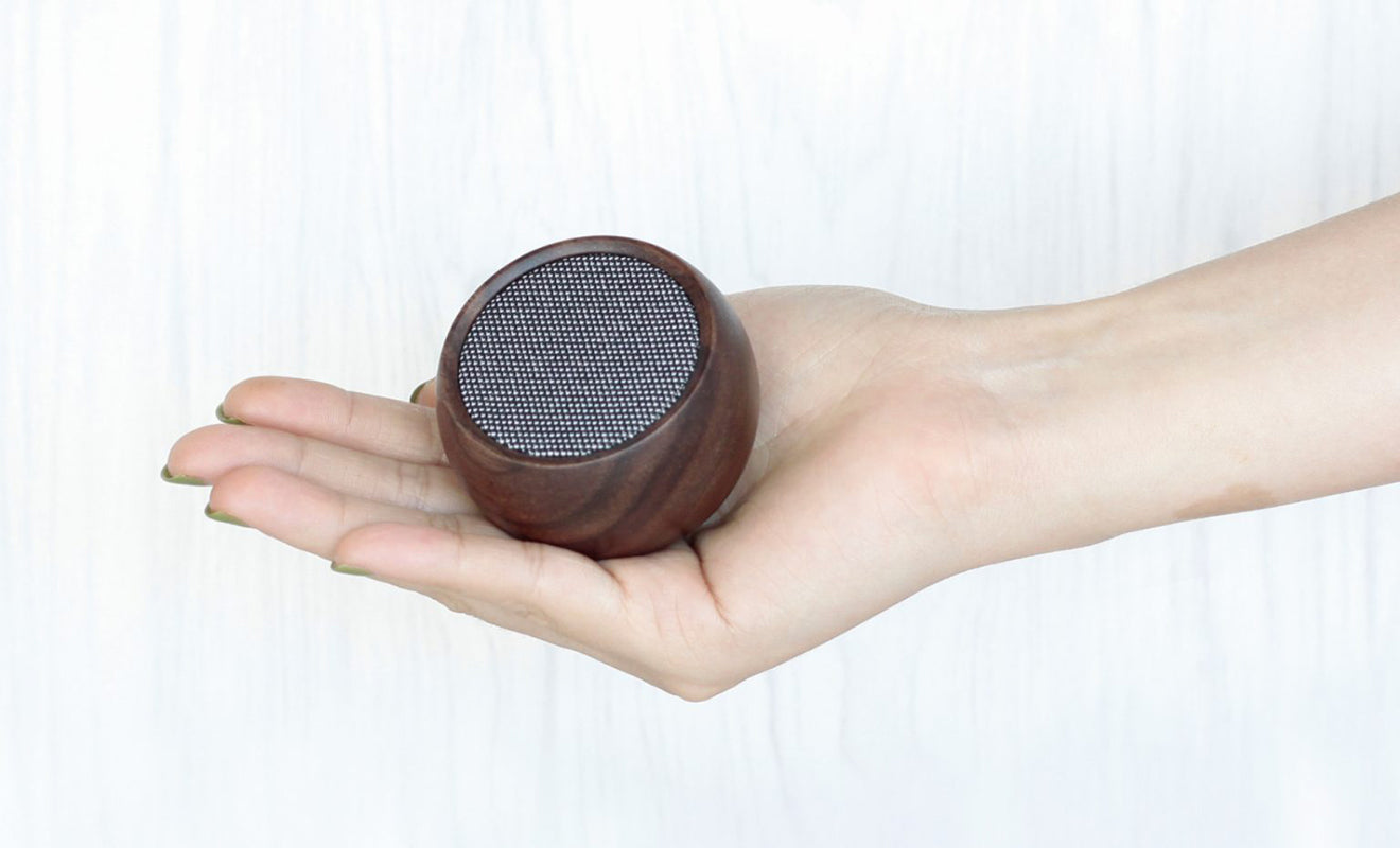 Gingko Designs tumbler speaker, shown held in a hand