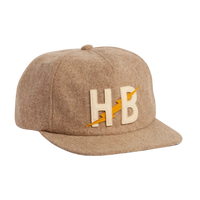 Big HB Unstructured Snapback Hat in Cowhide, tan heather wool cap with cream and yellow HB lightning bolt leather patch, three-quarter view -- The Simple Man