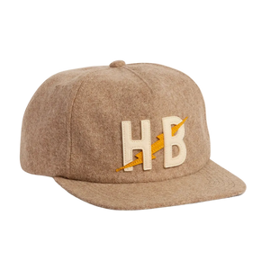 Big HB Unstructured Snapback Hat in Cowhide, tan heather wool cap with cream and yellow HB lightning bolt leather patch, three-quarter view -- The Simple Man