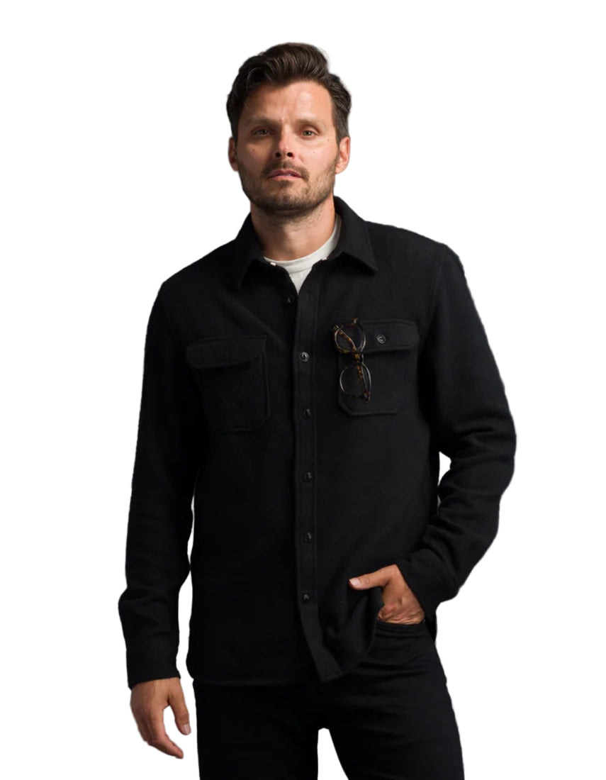 Men’s black Houndstooth Flannel Utility Shirt with sunglass pocket detail, styled casually.