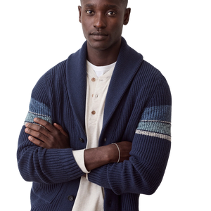 Man with arms crossed in the navy Varsity Shawl Cardigan over a cream henley, showing the striped sleeves