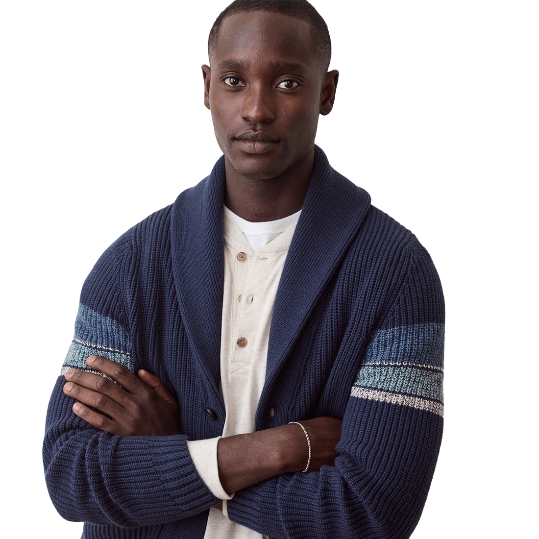 Close view of the navy shawl collar and striped sleeve on the Varsity Cardigan, worn over a henley