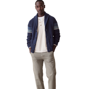 Man in the navy Varsity Shawl Cardigan over a cream henley with light chinos, full-length front view