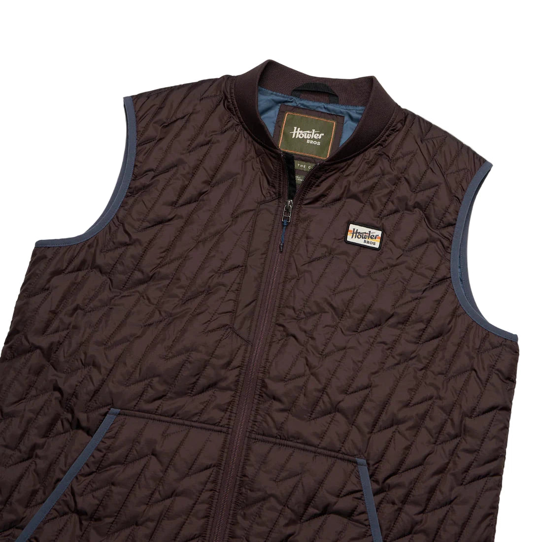 Laid flat Voltage Quilted Vest showing ripstop texture, snap chest pocket, and ribbed collar
