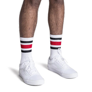 Men’s black and red striped crew socks on white base worn with white sneakers, American made athletic socks