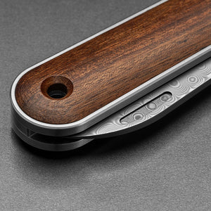 The James Brand Wayland rosewood Damasteel knife lifestyle shot on surface